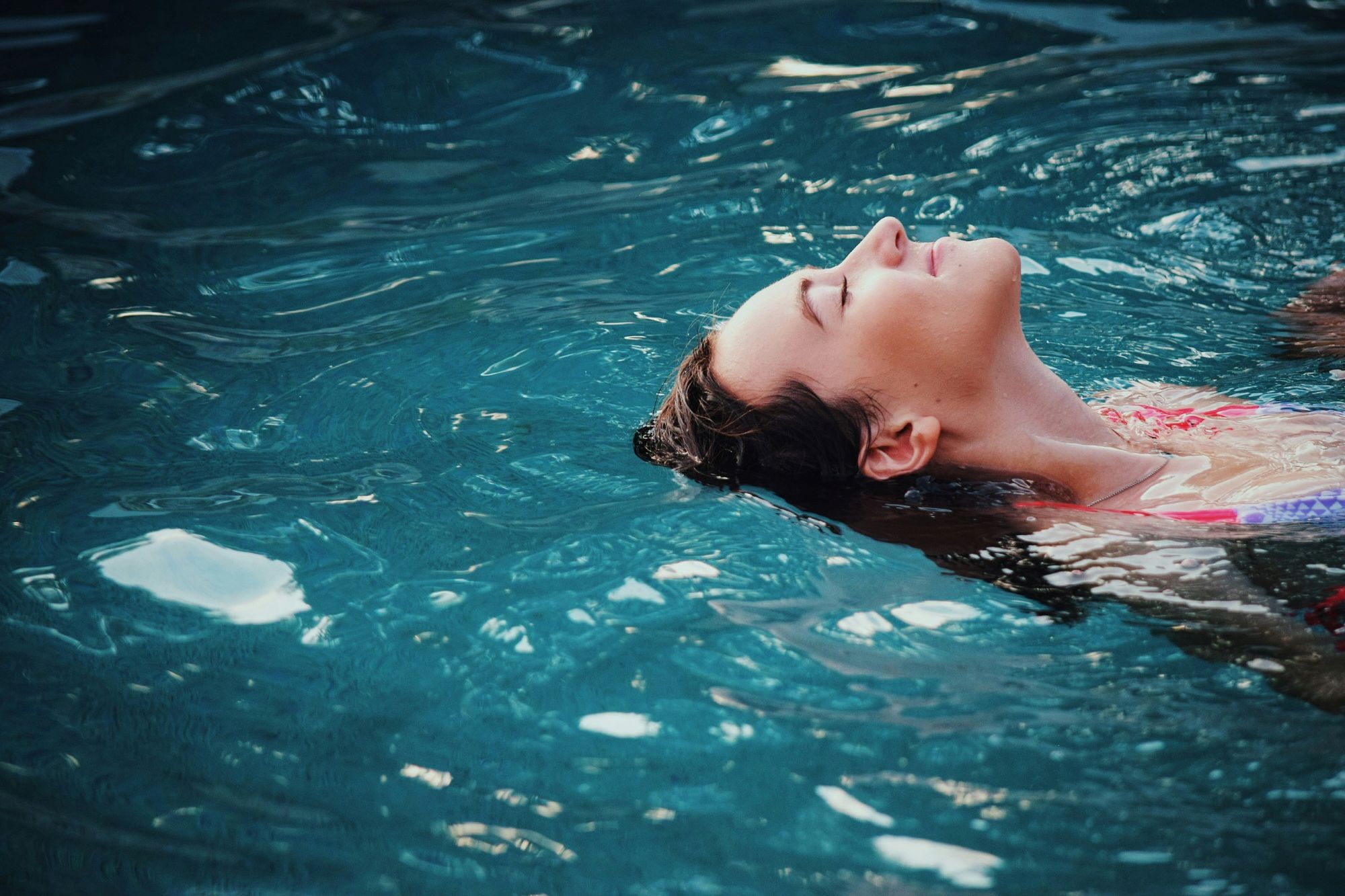 A woman floating in a pool.