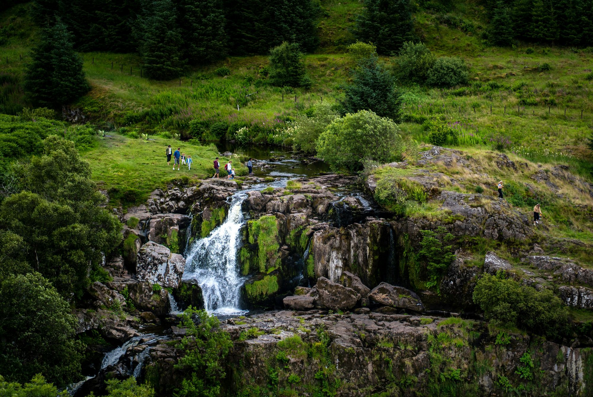 A group of people crossing the Loup of Fintry.