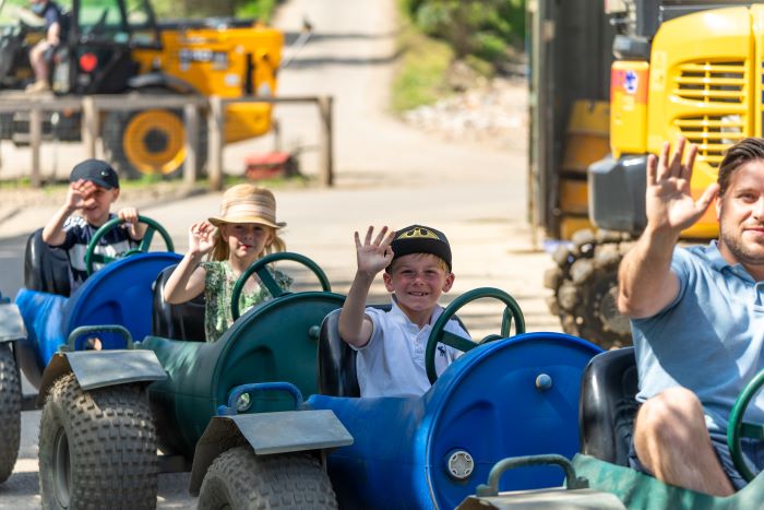 A group of children riding on the Diggerland train ride.