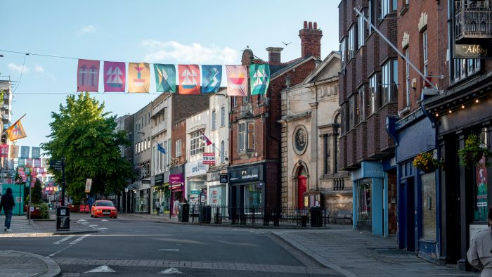 A street in Gloucester with colourful flags.