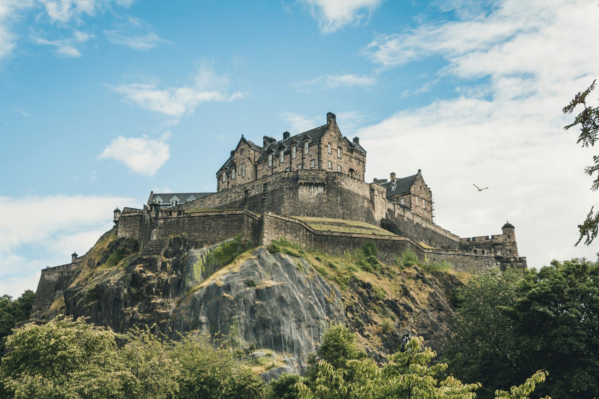 Edinburgh Castle perched on Castle Rock surrounded by greenery