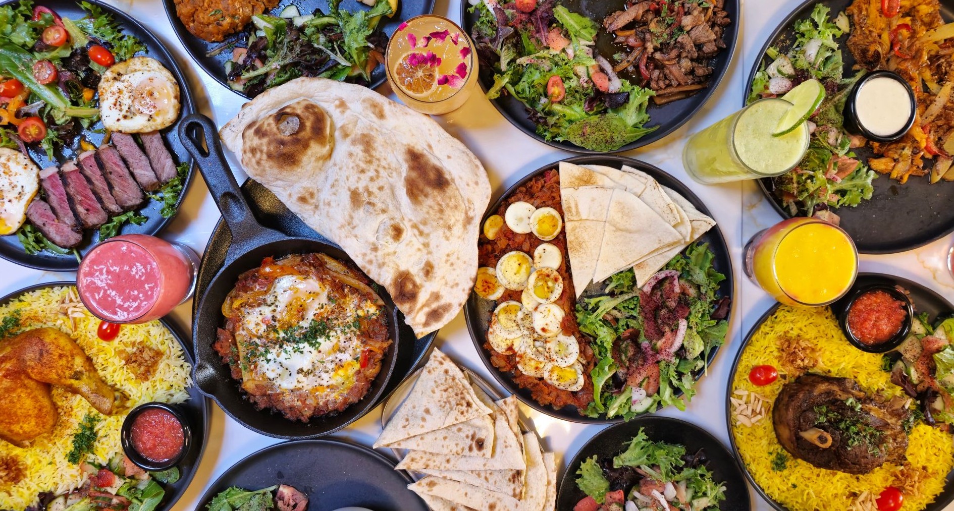 Top-down view of a vibrant Middle Eastern food spread on a table.