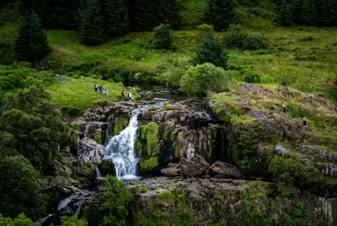 A group of people crossing the Loup of Fintry.