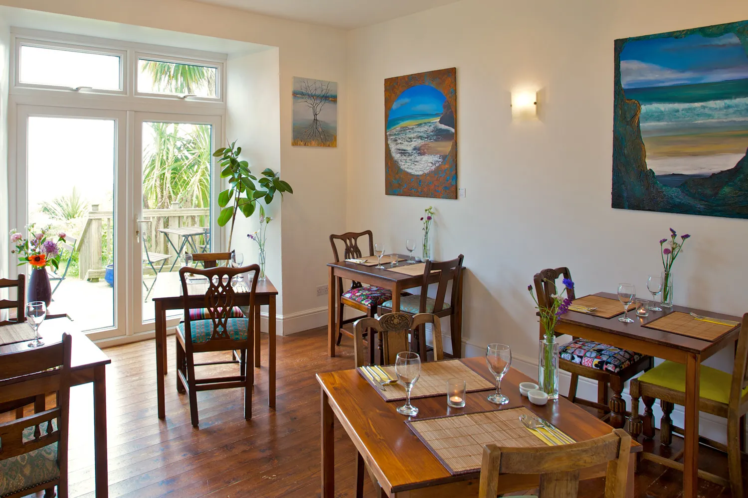 The Bean Inn dining room with flowers and wine glasses at every table.