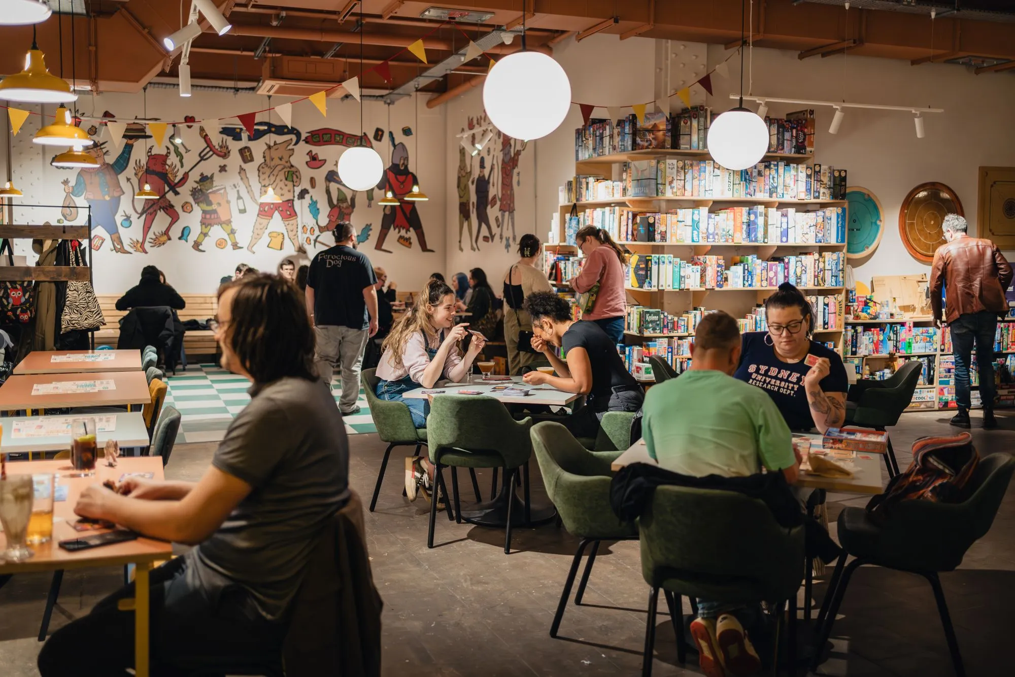 A group of people playing board games at Chance & Counters