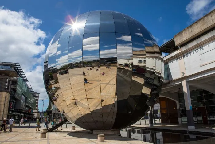 A large, mirrored sphere in Millennium Square, Bristol – the We The Curious planetarium.