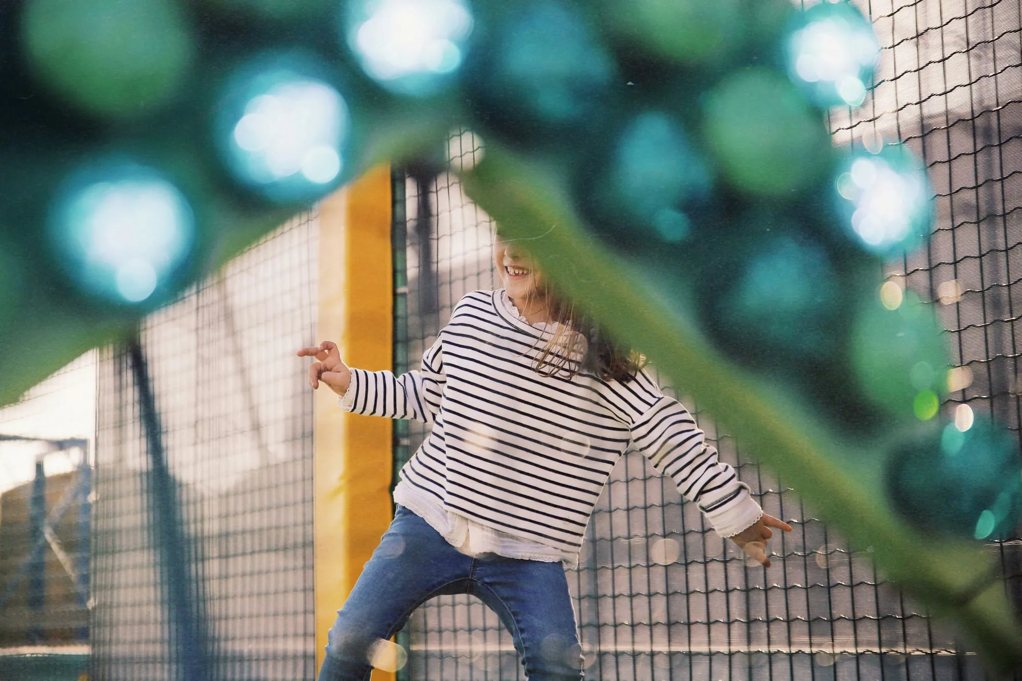 Child playing inside an indoor soft play area.