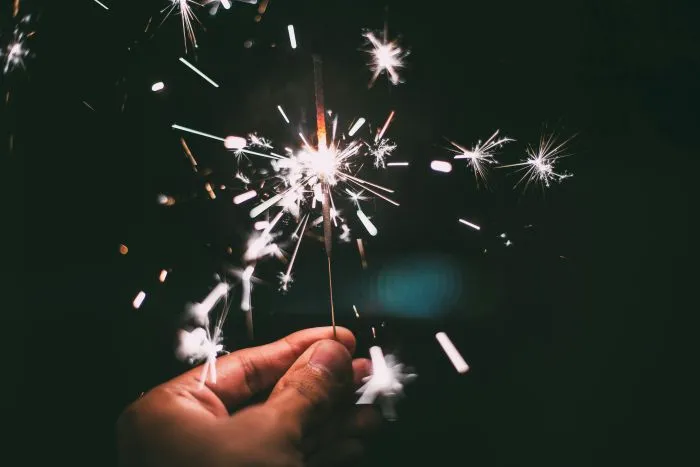A hand holding a sparkler.