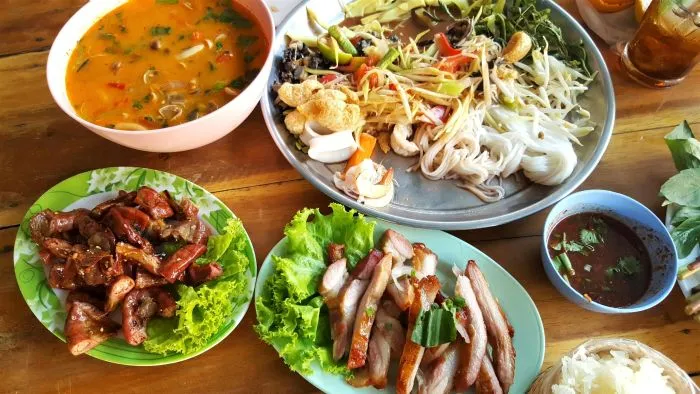 A spread of Thai food laid out on a table.